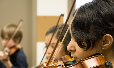 Young students play violin