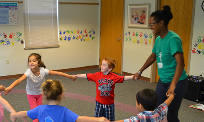An instructor and students dancing