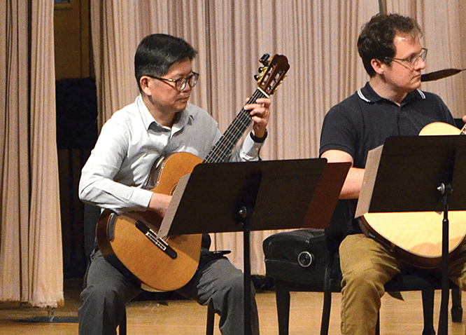 Richard Zhang performs with the adult guitar ensemble