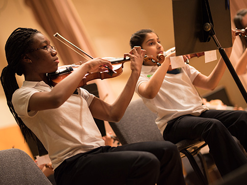 Suzuki Academy violin students play in ensemble